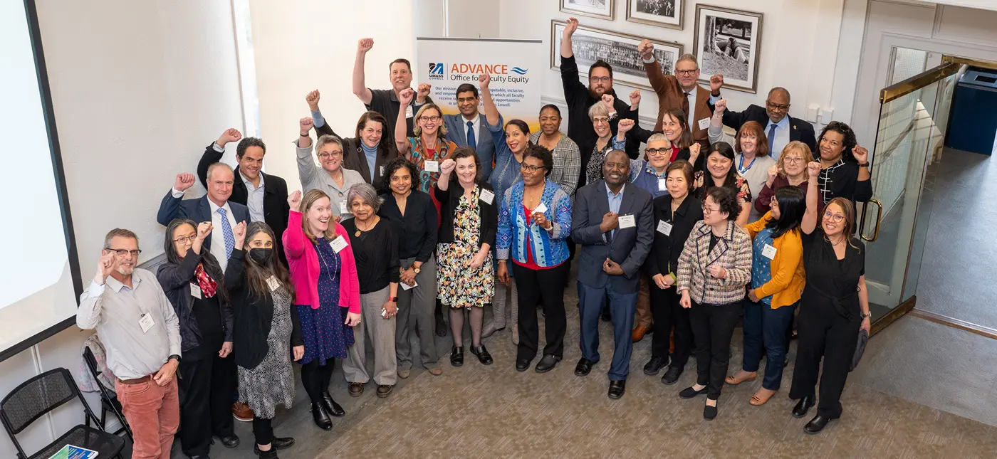 Group of people celebrating Summit success with hands raised.